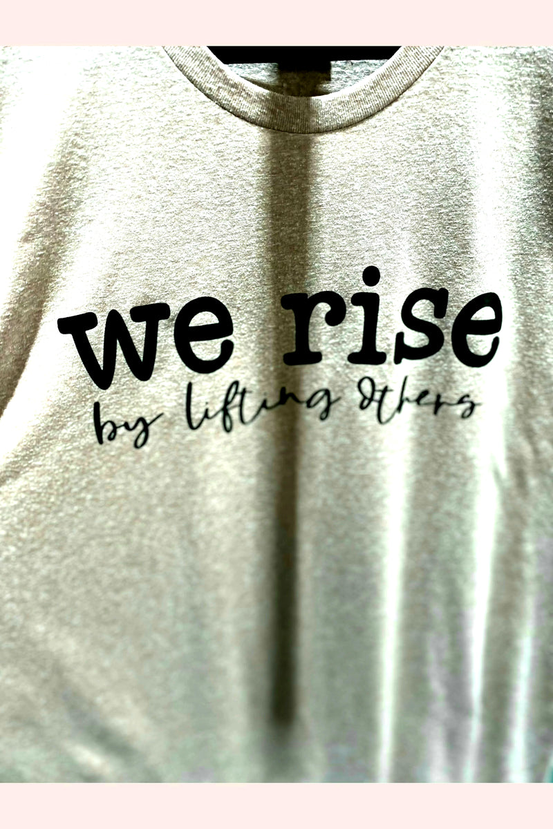 We rise by lifting others graphic tee.